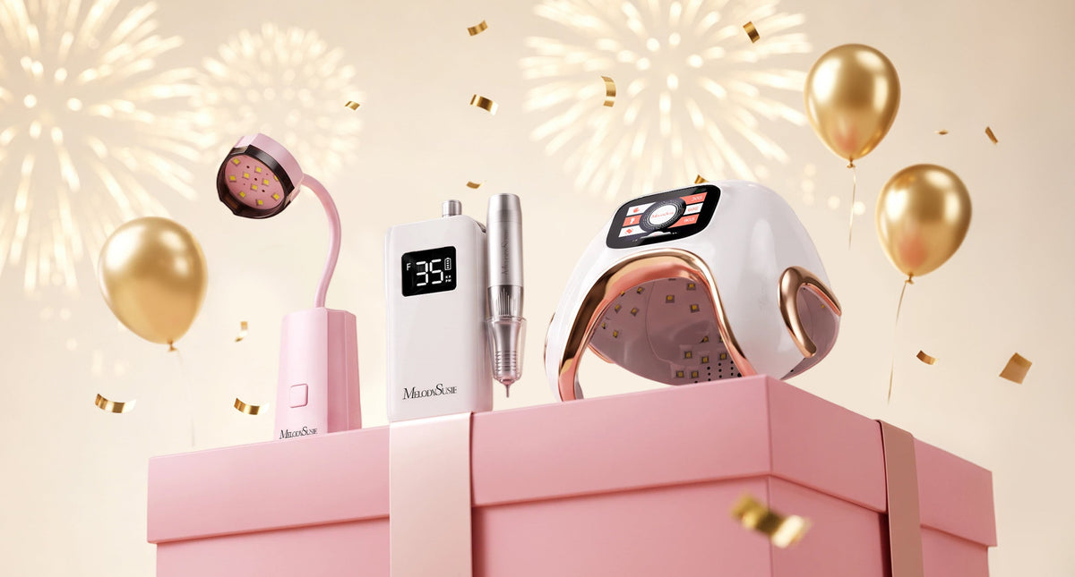 MelodySusie nail care tools and UV nail lamp displayed on a pink gift box, surrounded by gold balloons, confetti, and festive decorations.